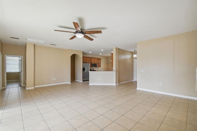 unfurnished living room featuring ceiling fan and light tile patterned flooring