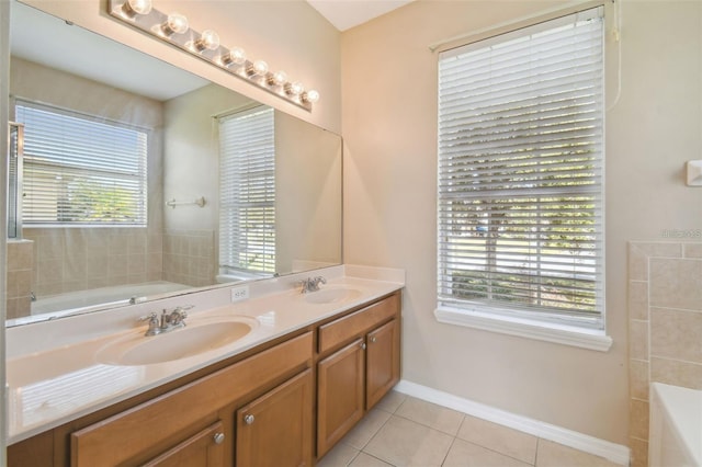 bathroom featuring vanity, tile patterned floors, and a bath