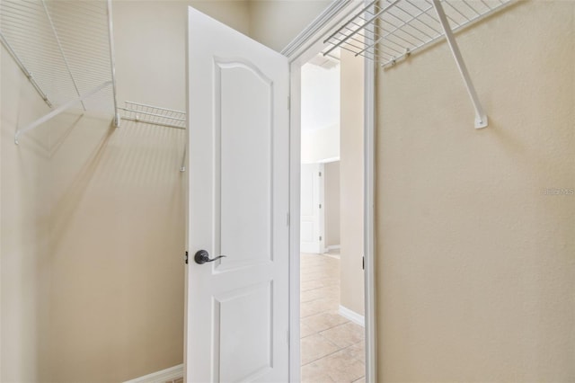 spacious closet with light tile patterned floors