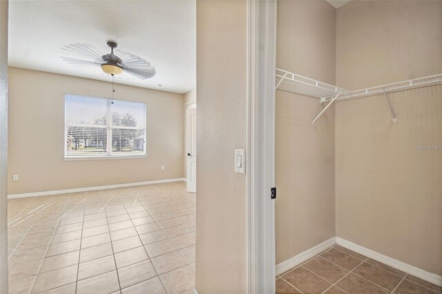 walk in closet featuring tile patterned floors and a ceiling fan