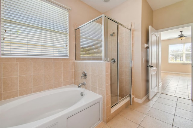 bathroom featuring ceiling fan, plus walk in shower, and tile patterned flooring