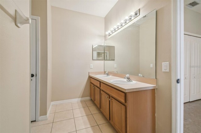 full bathroom with tile patterned floors, a sink, visible vents, and double vanity