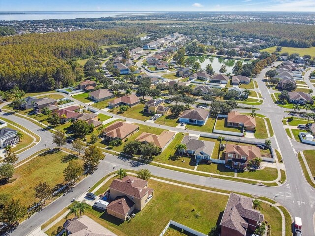 drone / aerial view with a view of trees and a residential view