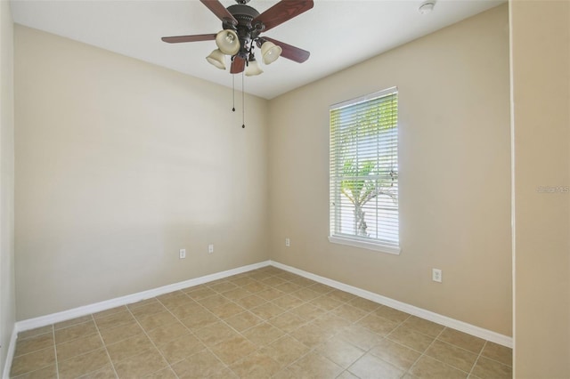 tiled spare room featuring ceiling fan