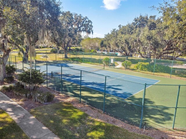view of tennis court featuring fence