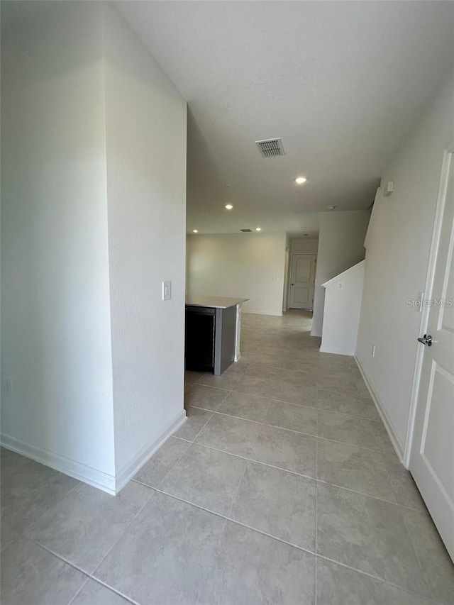 hallway with light tile patterned floors