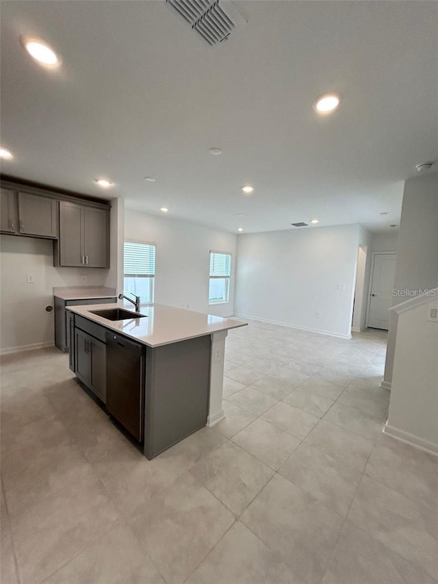 kitchen featuring sink, dishwasher, and a kitchen island with sink