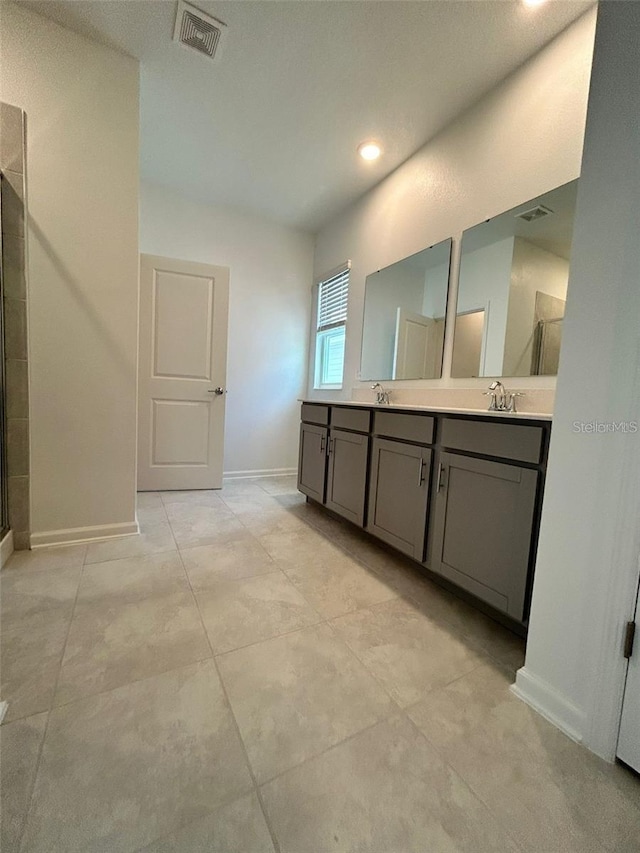 bathroom featuring vanity and a shower with shower door