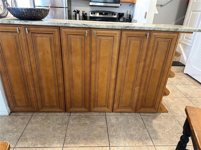 kitchen with stainless steel appliances and tile patterned floors