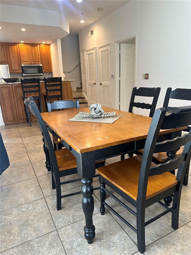 dining space featuring light tile patterned floors