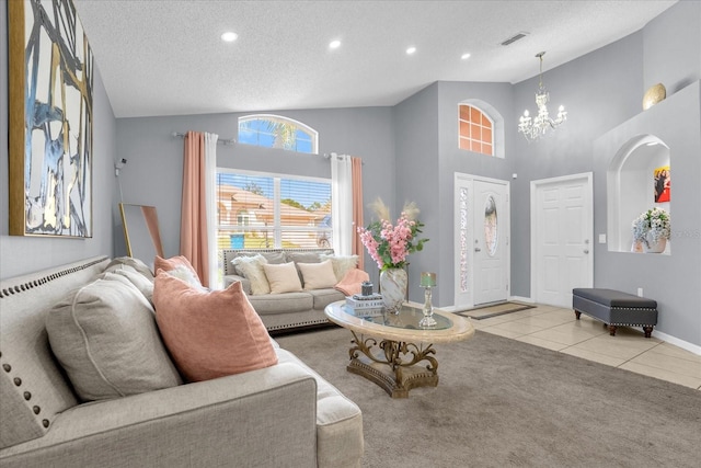 carpeted living room featuring high vaulted ceiling, a textured ceiling, and an inviting chandelier