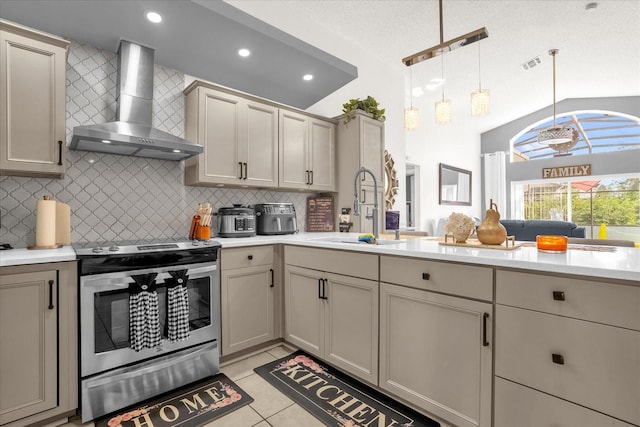 kitchen with wall chimney range hood, a textured ceiling, sink, stainless steel range with electric stovetop, and decorative light fixtures