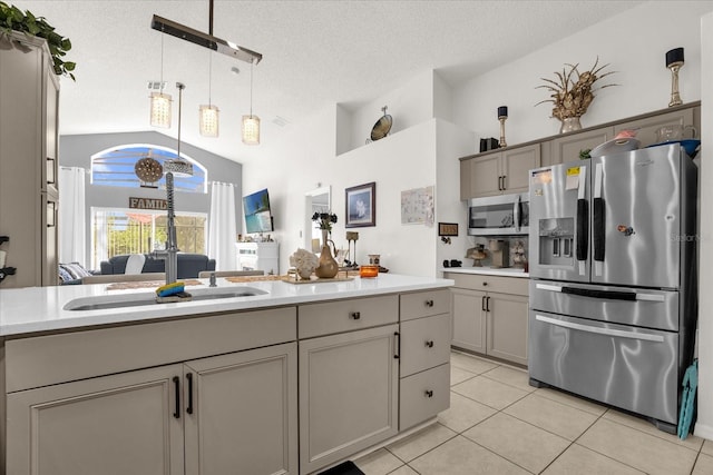 kitchen with gray cabinetry, appliances with stainless steel finishes, and a textured ceiling