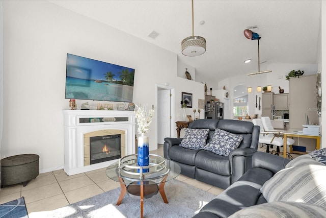 living room with high vaulted ceiling and light tile patterned floors