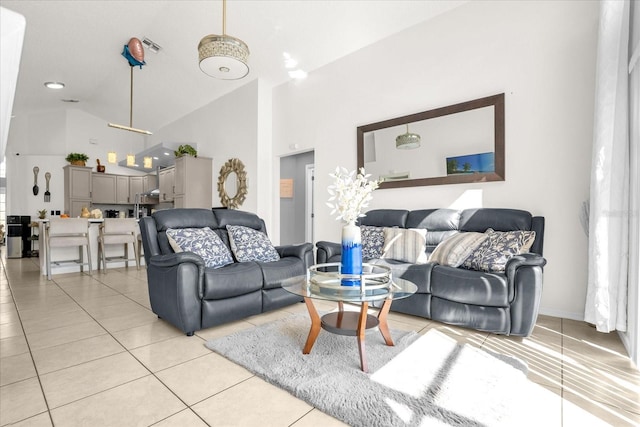 living room with light tile patterned flooring and high vaulted ceiling