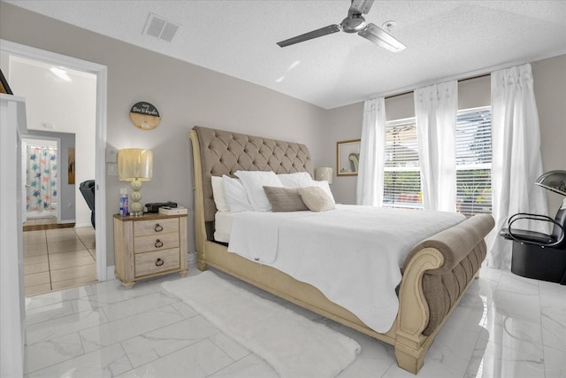 bedroom featuring a textured ceiling and ceiling fan