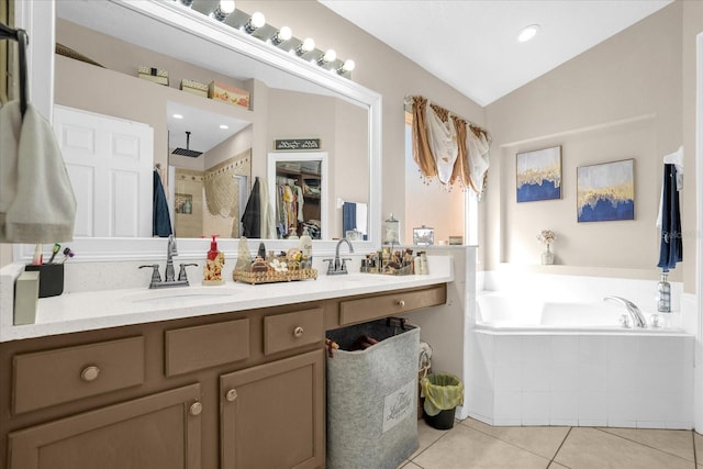 bathroom with vanity, separate shower and tub, vaulted ceiling, and tile patterned floors