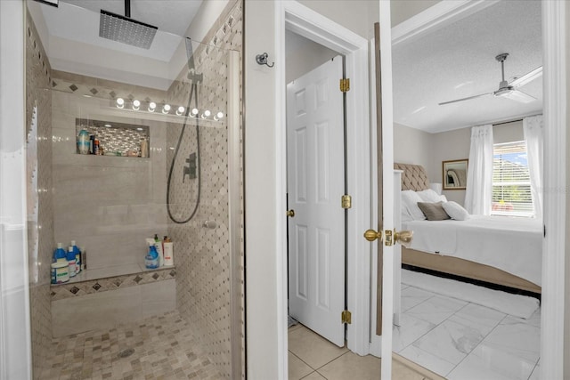 bathroom featuring tiled shower, a textured ceiling, and ceiling fan