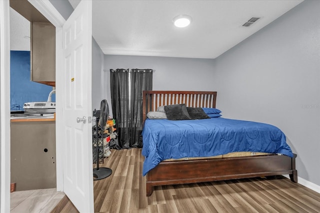 bedroom with light hardwood / wood-style floors