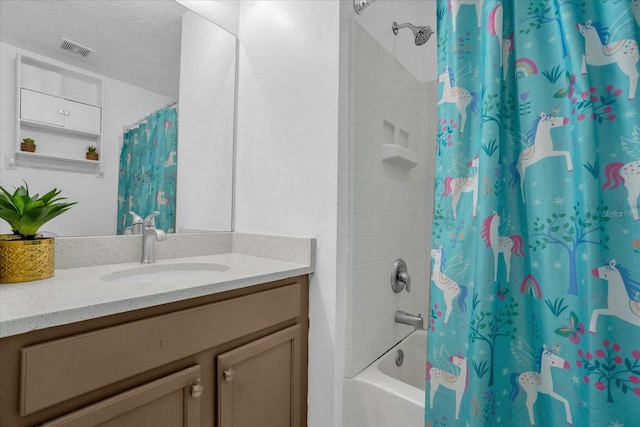 bathroom with vanity, a textured ceiling, and shower / tub combo with curtain