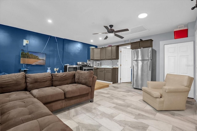 living room with sink and ceiling fan