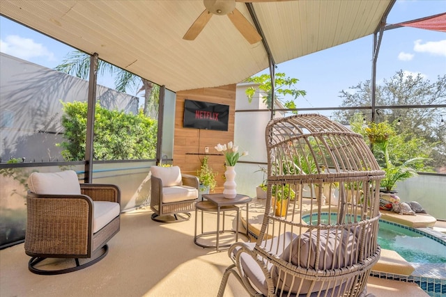 sunroom with ceiling fan, plenty of natural light, and a swimming pool