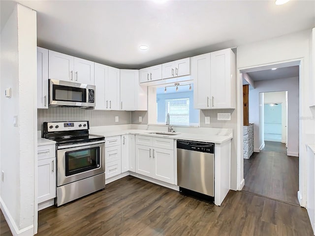 kitchen featuring white cabinets, stainless steel appliances, and dark wood-type flooring