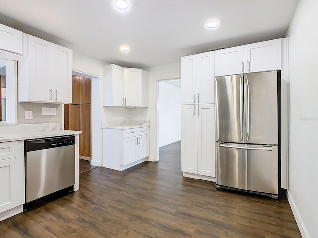 kitchen featuring white cabinets, stainless steel appliances, and dark hardwood / wood-style flooring