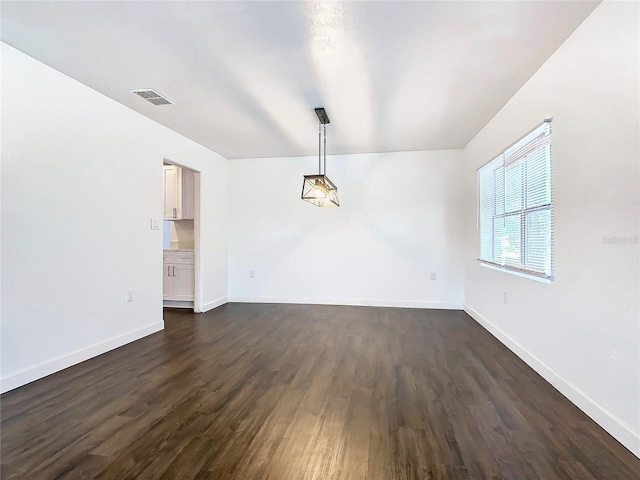 unfurnished room with dark wood-type flooring