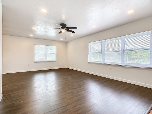 empty room featuring ceiling fan and dark hardwood / wood-style flooring