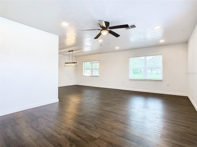 empty room with dark wood-type flooring and ceiling fan