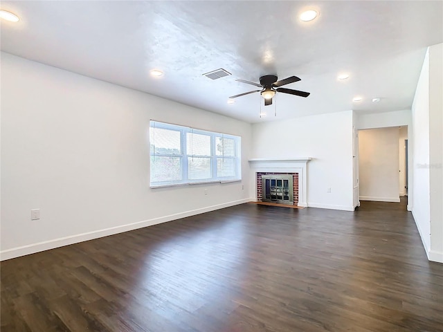 unfurnished living room with dark hardwood / wood-style floors, a fireplace, and ceiling fan