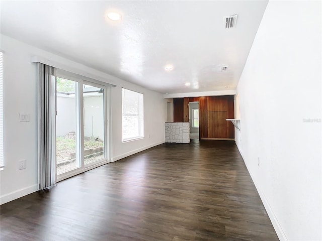 unfurnished living room with dark wood-type flooring