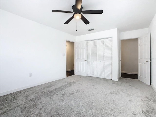 unfurnished bedroom featuring a closet, carpet, and ceiling fan