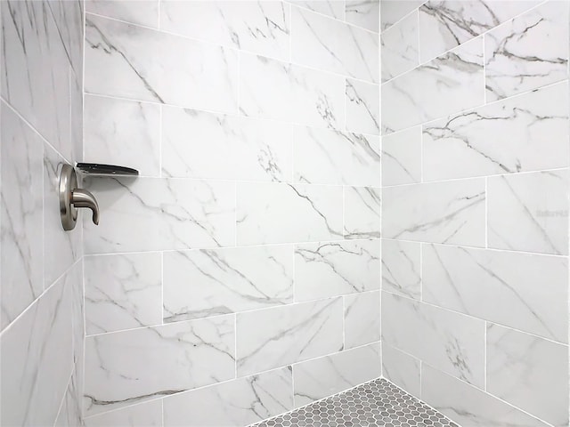 bathroom with a tile shower