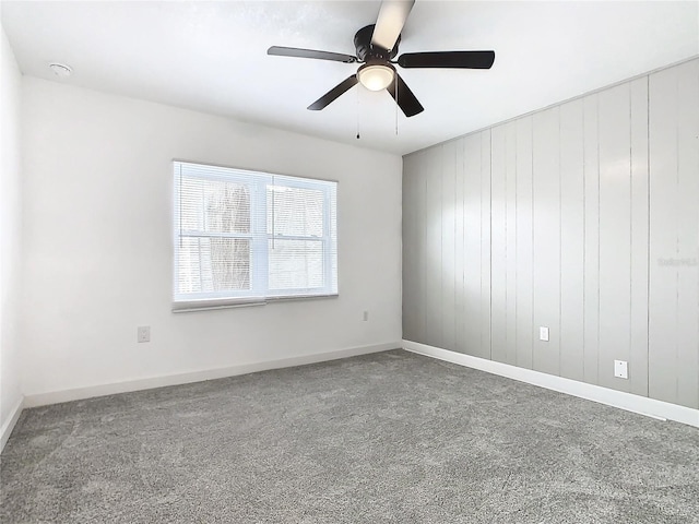 spare room with ceiling fan and carpet