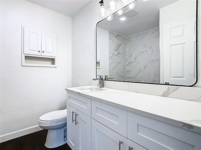 bathroom with vanity, hardwood / wood-style flooring, and toilet