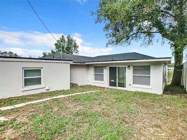 back of house featuring a lawn