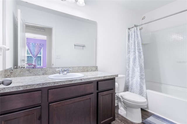 full bathroom featuring vanity, hardwood / wood-style floors, shower / bath combo, and toilet