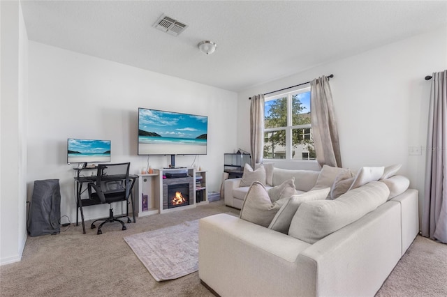 living room featuring light carpet and a textured ceiling