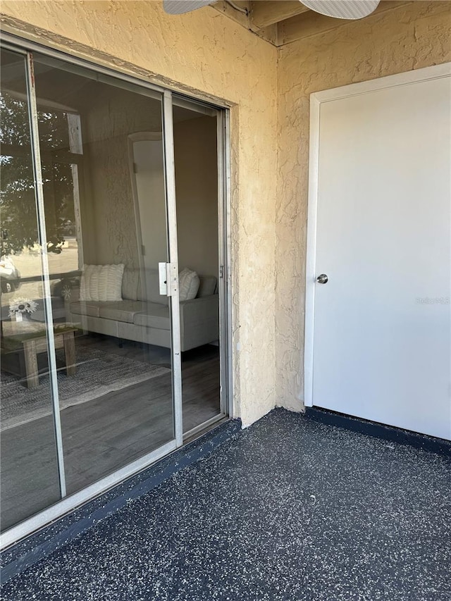 doorway to property with stucco siding