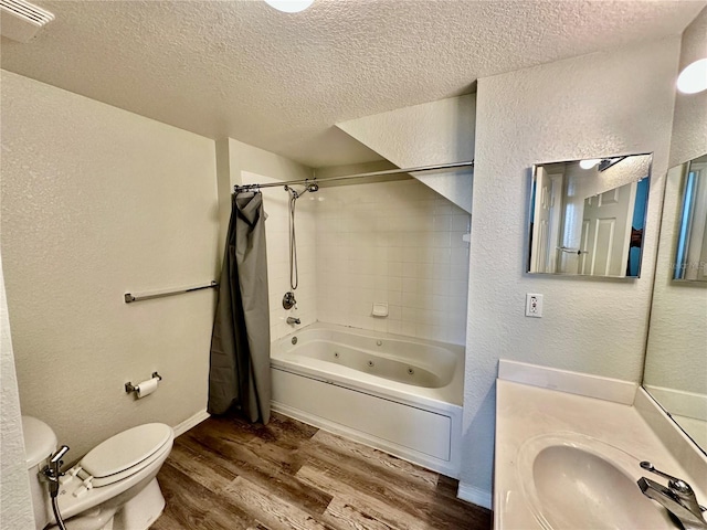 full bathroom with shower / bath combo, wood-type flooring, a textured ceiling, and toilet