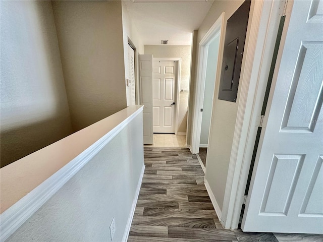 hallway with dark hardwood / wood-style floors and electric panel