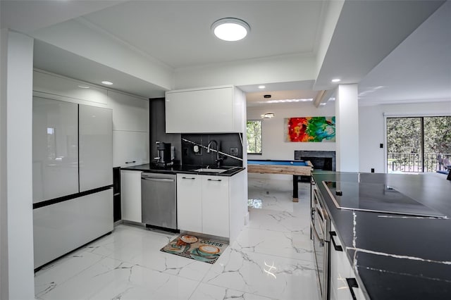 kitchen with marble finish floor, a fireplace, dark countertops, dishwasher, and fridge