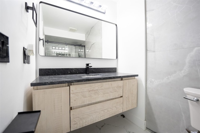 bathroom with visible vents, marble finish floor, vanity, and toilet