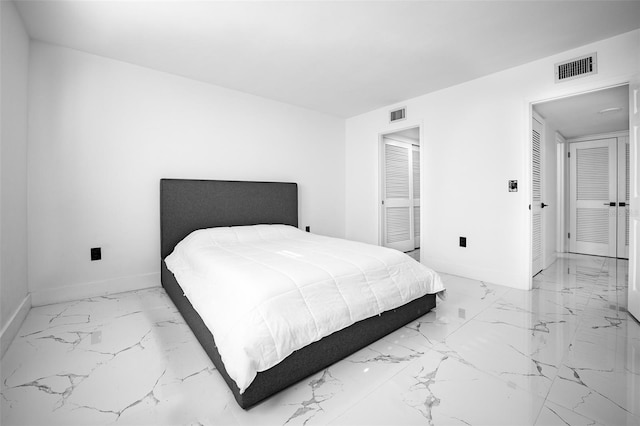 bedroom featuring marble finish floor, baseboards, and visible vents