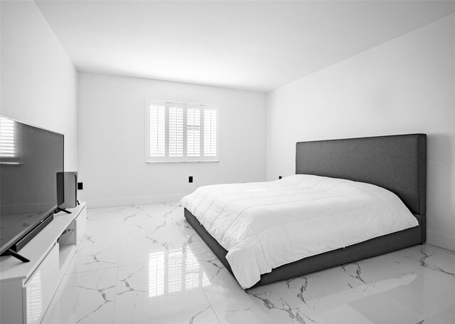 bedroom with marble finish floor and baseboards