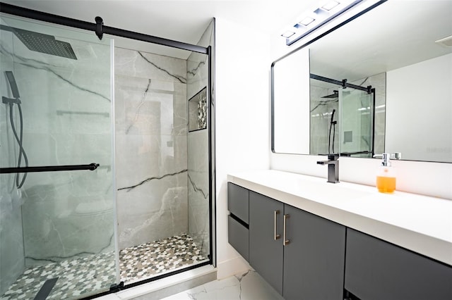 bathroom with marble finish floor, a marble finish shower, and vanity