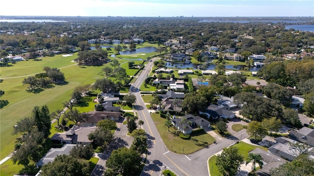 drone / aerial view with golf course view, a water view, and a residential view