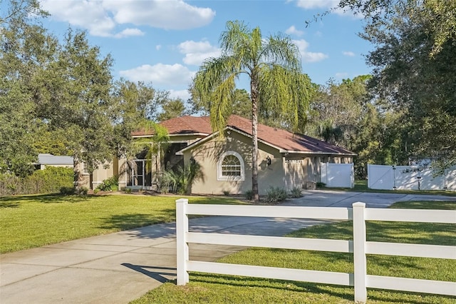 mediterranean / spanish house featuring a front lawn